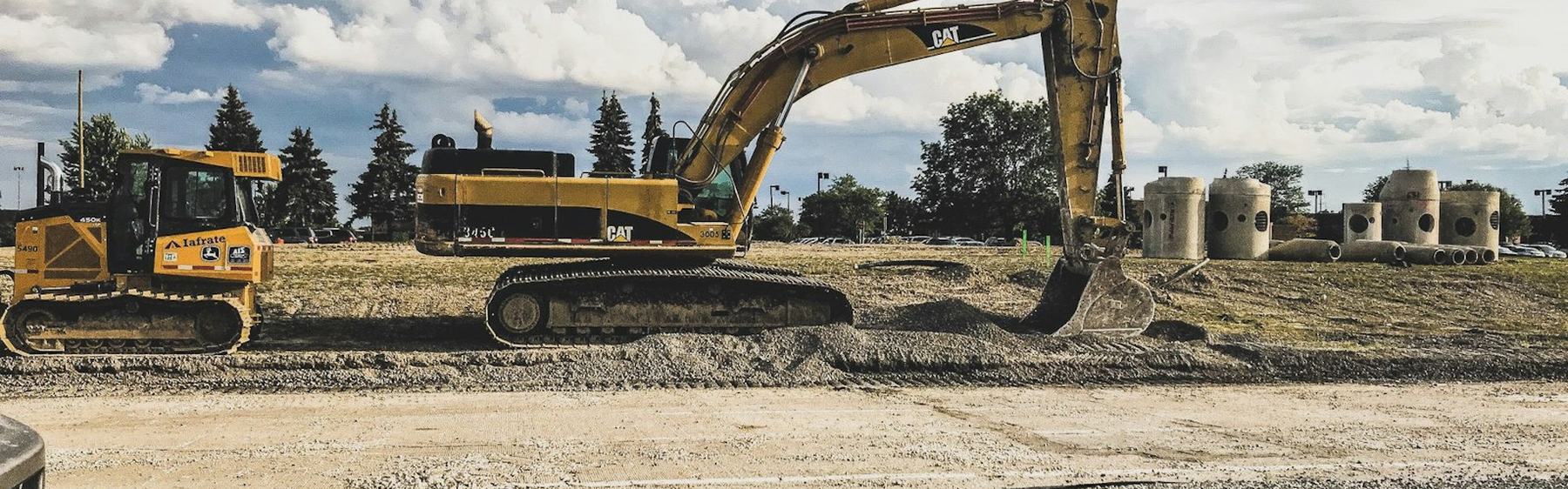 Earthmoving plant working alongside a newly surfaced road