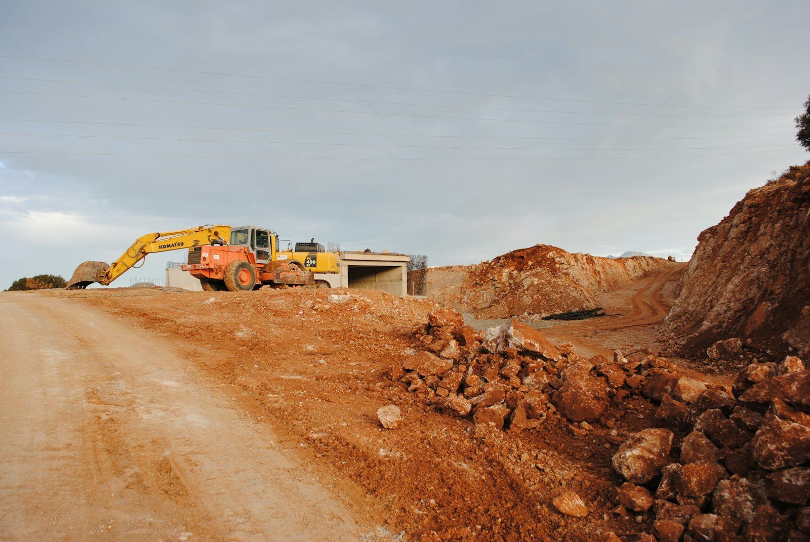 Excavator and earthmoving equipment working on a site cutting